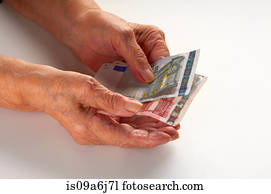 Older woman holding Euro notes