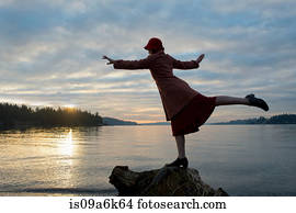 Woman balancing on rock formation