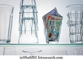 British currency in glass on shelf