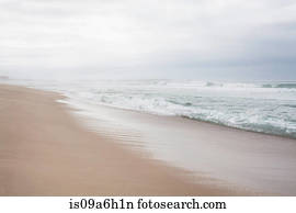 Peaceful beach scene with misty horizon