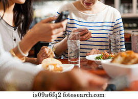 People at restaurant texting