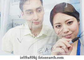 Woman writing on glass with marker pen