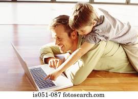 Father and son playing with a laptop