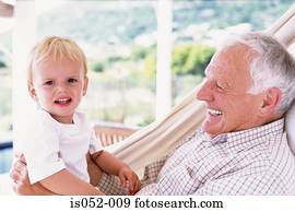 Grandad with grandson in a hammock