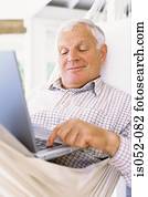 Granddad with a laptop in a hammock Granddad with a laptop in a hammock