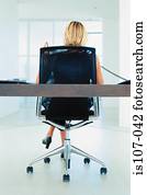 Businesswoman working on modern office furniture