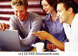 Men and woman discussing work at bar