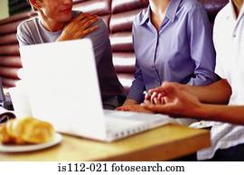 Men and woman discussing work at bar
