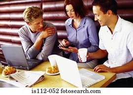 Men and woman discussing work at bar