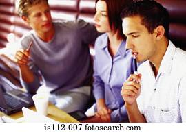 Men and woman discussing work at bar