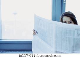 Businesswoman reading stocks and shares