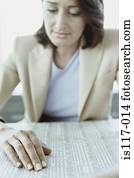 Businesswoman reading stocks and shares