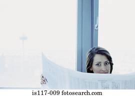 Businesswoman reading stocks and shares
