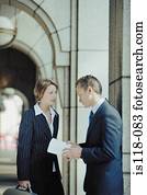 Businessman and businesswoman talking outside office
