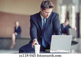 Businessman outside with laptop 