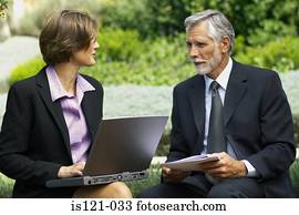Businessman and businesswoman in a meeting outside