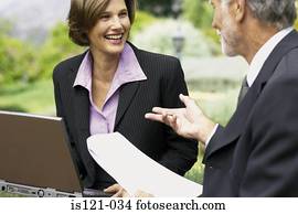 Businessman and businesswoman in a meeting outside