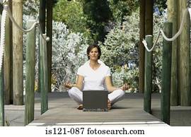 Woman with computer doing yoga