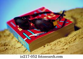 Sunglasses and book