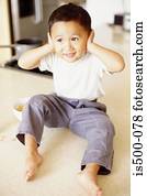 Boy with hands over ears
