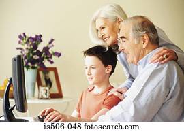 Grandparents and grandson using computer