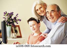 Grandparents and grandson using computer