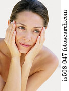 Woman holding face in hands