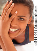 Smiling young woman partially covering face