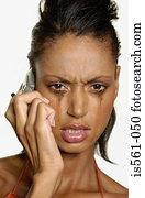 Crying woman using cellular telephone