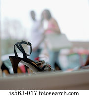 Couple walking past shoe store