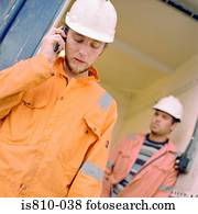Construction worker using cellular telephone