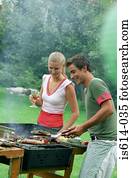 Friends cooking on barbeque. Friends cooking on barbeque.