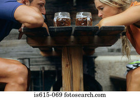 Tired cyclists sit with beers.