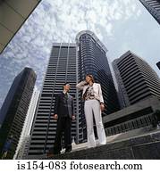 Asian businesspeople using a cellular telephone