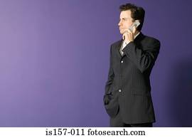 Businessman using cellular telephone
