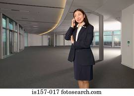 Businesswoman using a cellular telephone