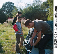 Family erecting a tent