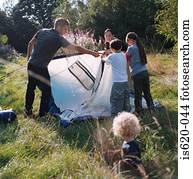 Family erecting a tent