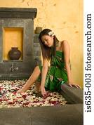 Woman in bath with petals