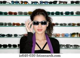 Woman shopping for sunglasses