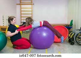 Girl exercising on fitness ball