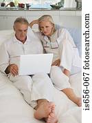Mature couple using laptop