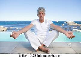Mature man in yoga position 
