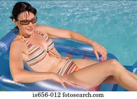 Woman on inflatable in swimming  pool 