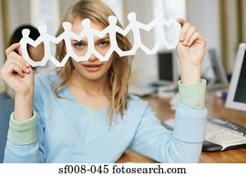 Woman holding up paper chain