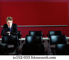 Businessman sitting alone in room
