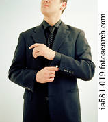 Businessman adjusting sleeve