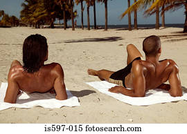 Men sunbathing on beach