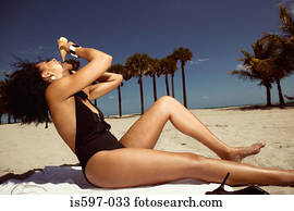 Woman eating ice cream on beach
