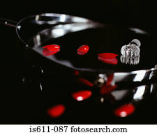 Fake fingernails and a perfume bottle top